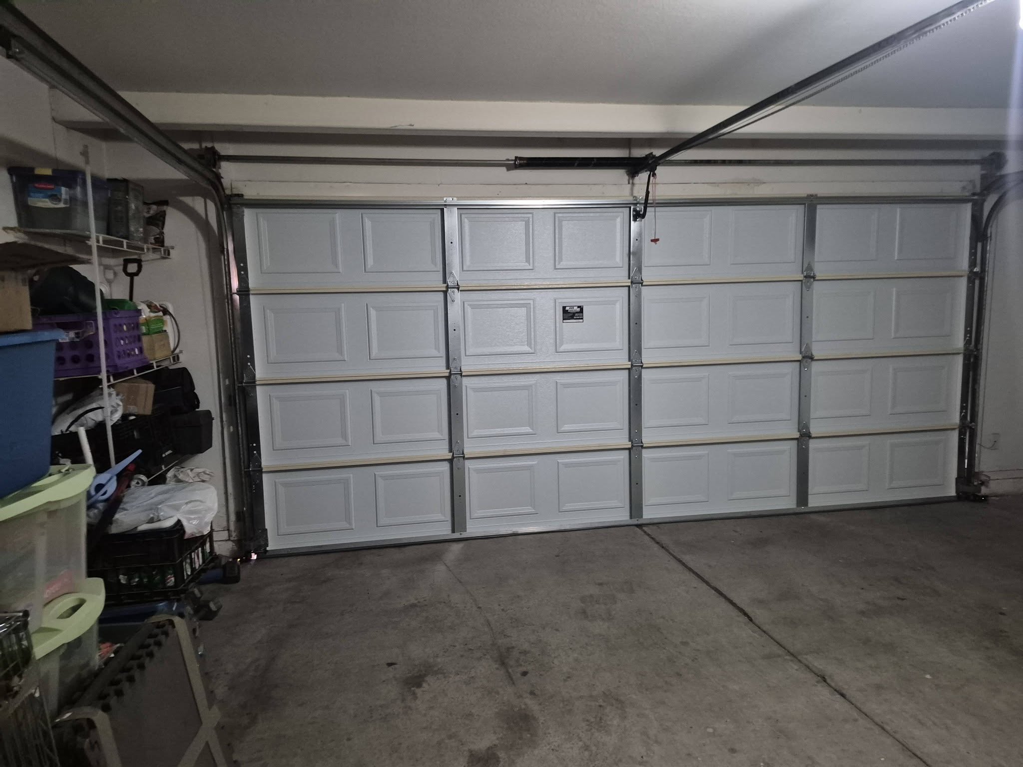 Interior view of a residential sectional garage door and opener system shared by J&B Garage Doors
